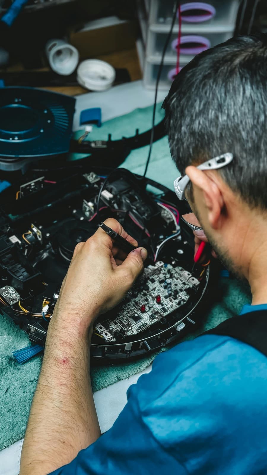 A technician servicing a cleaning machine in a workshop